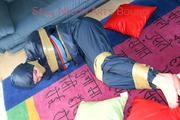 Jill tied, gagged and hooded on the floor with tape wearing an oldschool rain combination (Pics)