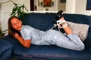 Stella bound and gagged in a shiny nylon jumpsuit