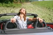 Stella tied and gagged in a grey shiny nylon catsuit in a car
