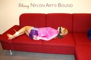 Samantha tied and gagged on a sofa wearing a sexy purple nylon shorts and a pink rain jacket (Pics)