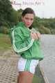 Watching ***OUR SEXY ARCHIVE MODEL JENNY*** wearing a sexy white shiny nylon shorts and a green shiny nylon rain jacket posing for you (Pics)