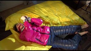 Lucy tied and gagged on a pillory on a bed wearing a supersexy crazy sensation downwear (Video)