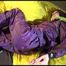 Lucy tied, gagged and hooded on bed on a bar wearing sexy purple rainwear (Video)