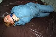 Katharina tied and gagged in a blue skisuit
