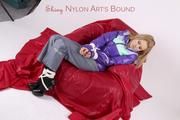 Samantha in grey rainsuit and purple down jacket tied and gagged on a red chair (pics)