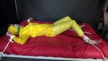 Watching sexy Pia being tied and gagged with ropes on a bed and a clothgag wearing sexy yellow shiny nylon rainwear (Video)