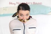 JIll tied and gagged on a white sofa wearing a sexy white/red shiny nylon shorts and a white rain jacket (Pics)