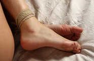 Ballgagged nude barefoot Alberta, hogtied with hemp rope, wiggles and rolls on the bed