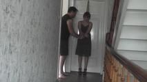 Kim tied to the door