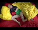 Sexy Sonja wearing a green shiny nylon shorts and a black rain jacket lolling in shiny nylon linen (Video)