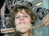 19 Yr OLD SINGLE MOM RONI IS WRAP CLEAVE GAGGED WITH AN ACE BANDAGE, HANDGAGGED, MOUTH STUFFED, BALL-GAGGED & TIED BACKWARDS TO A CHAIR (D53-9)