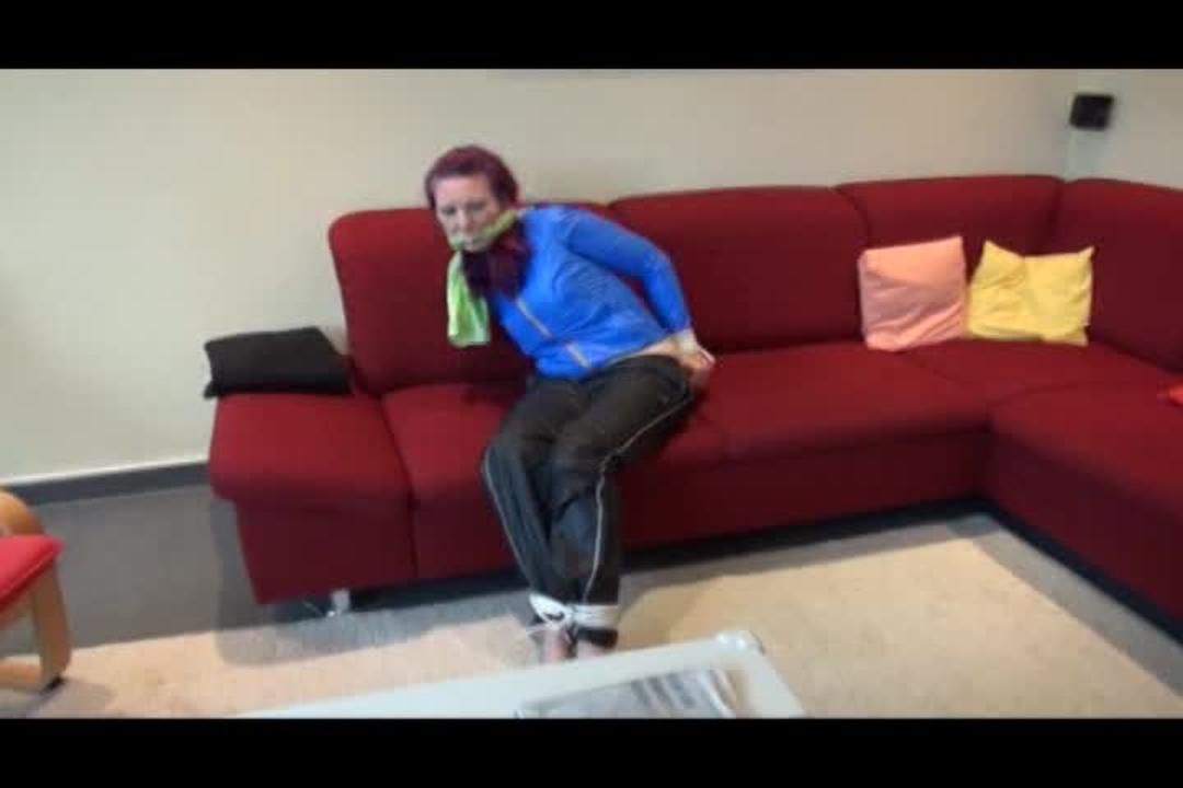 Mara Tied And Gagged On A Sofa Wearing A Shiny Black Rain Pants And A Got Lightblue Rain Jacket (Video)