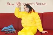Jill ties, gagges and hoodes herself wearing a shiny yellow down jacket and a yellow rain pants(Pics)