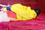 ***LUCIE*** wearing red/yellow shiny nylon shorts and a yellow shiny nylon rain jacket being bound on a sofa with ropes and a ball gag (Pics)
