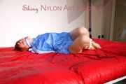 Sonja tied and gagged on bed with ropes wearing a sexy lightblue shiny nylon shorts and a lightblue rain jacket (Pics)