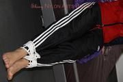 Samantha tied and gagged on bed wearing shiny nylon rainwear (Pics)
