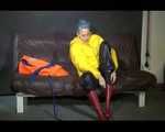 Sexy Mara trying on her new yellow down jacket and her lifevest in combination with a sexy shiny black rain pants and rubber boots (Video)