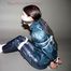 One of our archive girls tied and gagged in shiny nylon rainwear