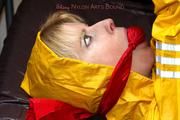 Pia tied and gagged in a shiny nylon rainsuit 