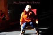 Pia tied and gagged on a chair wearing a shiny orange down jacket and a shiny blue rain pants (Pics)