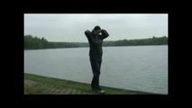 Sexy archive girl wearing shiny nylon shorts and puts on a rain pants and jacket (Video)