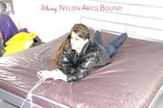 Shelly tied and gagged on a bed with downjacket and shiny rainsuit