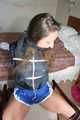 Stella being tied and gagged with ropes and a clothgag on a chair wearing a sexy shiny nylon short and a rain jacket (Pics)