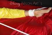 Watching sexy Pia being tied and gagged with ropes on a bed and a clothgag wearing sexy yellow shiny nylon rainwear (Pics)