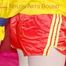 ***LUCIE*** wearing red/yellow shiny nylon shorts and a yellow shiny nylon rain jacket being bound on a sofa with ropes and a ball gag (Pics)