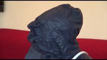 Jill tied, gagged and double hooded on a chair wearing shiny nylon shorts and two shiny nylon rain jackets (Video)