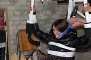 Katharina tied and gagged in a shiny nylon downcoat and shiny nylon pants