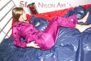Alina preparing her bed for relaxing and lolling on the bed wearing a sexy shiny nylon rain pants and a rain jacket (Pics)