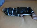 a video with one of our archive girls bound and gagged in a shiny black PVC sauna suit