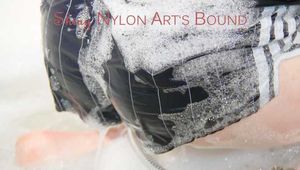 Sonja ties and gagges herself with cuffs in the bath tub wearing a sexy black shiny nylon shorts and a white/black rainjacket (Pics)