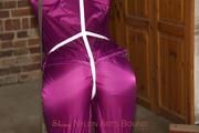 Katharina tied and gagged in a shiny nylon rainsuit