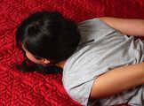 Ballgegged barefoot Lois in t-shirt and shorts, hog-cuffed on the floor with hinged cuffs, wiggles helplessly