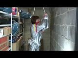a video with Nicole tied and gagged in a shiny silver PVC sauna suit