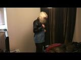 Blonde-haired archive girl going out wearing shiny nylon rainwear (Video)