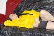Lucy wearing a sexy black/yellow shiny nylon shorts and a yellow rain jacket preparing her sofa with a special cloth to enjoy it (Pics)