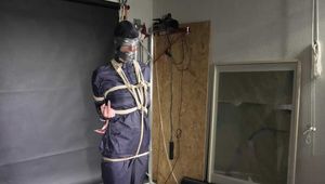 Myxxxy bound and gagged in a shiny nylon Rainsuit