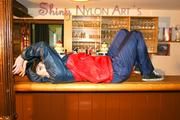 Jill posing in a bar wearing ONLY a sexy rainwear combination (Pics)