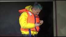 Watching Mara putting on a down jacket, rubber boots and a lifevest (Video)