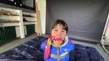 Lana tied and gagged in shiny nylon Rainwear desperately trying to free herself