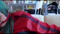 Mara tied and gagged on a white sofa wearing a blue shiny nylon shorts and a red/blue rain jacket (Video)