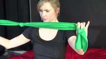 *** Sexy MIA wearing a green shiny nylon shorts and a black top ties and gagges herself with cuffs and a clothgag on a bed (Video)***