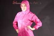 Mara wearing a sexy pink rainsuit posing infront of the camera in a studio (Pics)