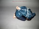 One of our archive girls tied and gagged in shiny nylon rainwear
