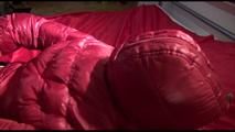 Lucy tied and gagged on bed wearing a sexy black shiny nylon pants and a red down jacket (Video)