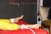 Watching sexy Pia being tied and gagged with ropes on a bed and a clothgag wearing sexy yellow shiny nylon rainwear (Pics)