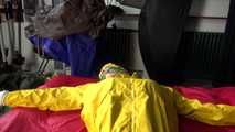 Watching sexy Pia being tied and gagged with ropes on a bed and a clothgag wearing sexy yellow shiny nylon rainwear (Video)